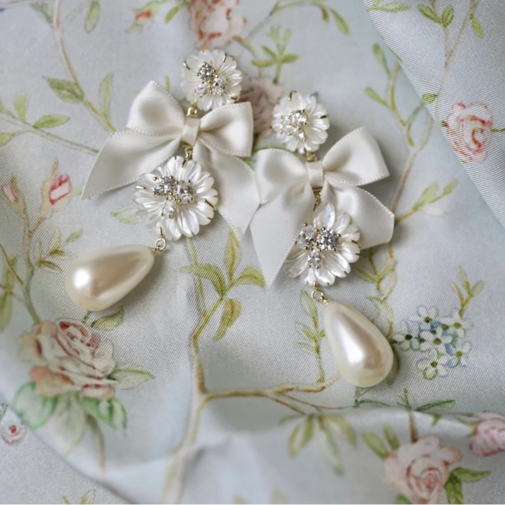 EMBELLISHED MOTHER OF PEARL + IVORY BOW EARRINGS BY NICOLA BATHIE
